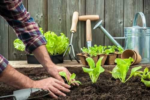 Team of gardeners with tools arriving at a property entrance
