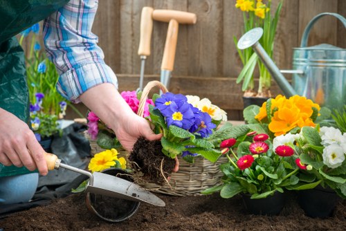 Maintenance team mowing and tending plants in a suburban garden